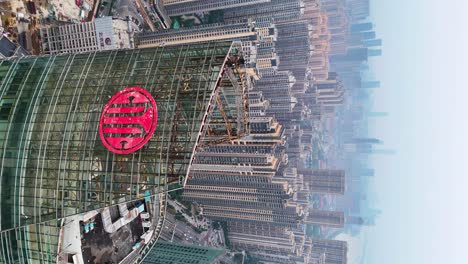 Vertical-fly-by-at-the-Citic-Bank-International-Tower-revealing-the-Changsha-cityscape-in-Hunan-Province-with-a-hazy-sky-and-residential-buildings