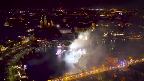 Fireworks-over-Wawel-Royal-Castle-and-Vistula-river-in-Krakow-during-Dragon-Parade,-Poland