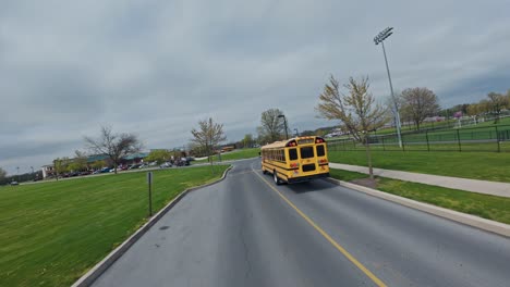 Fpv-following-shot-of-American-yellow-school-bus-on-ride