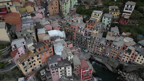 Riomaggiore-Cinque-Terre-Italy-aerial-rising-view-of-building-set-on-ocean