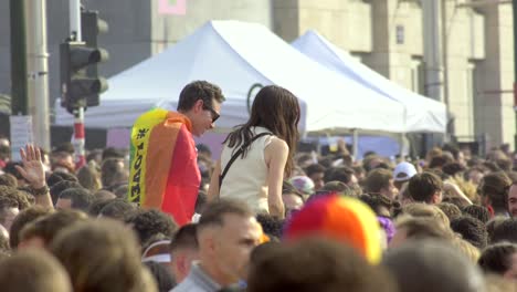 Young-couple,-woman-on-shoulders,-vibrant-celebration-scene