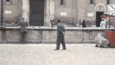 Man-Walks-Past-a-Stone-Wall-in-Piazza-del-Santo-in-Padua-in-1950s