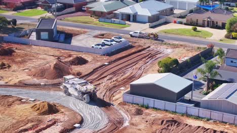 Aerial-overview-of-a-large-soil-stabiliser-working-on-a-road-at-a-new-construction-site