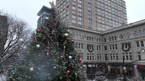 Rising-drone-shot-of-Lancaster-Clock-in-front-of-tower-building-during-Christmas-time