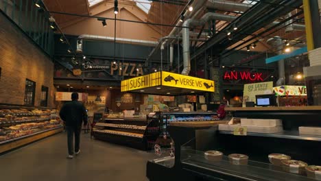 Interior-footage-of-Jumbo-food-market-in-Amsterdam,-featuring-fresh-sushi-and-fish-counters