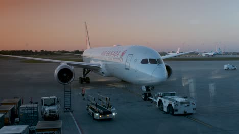 Airplane-leaving-the-gate-being-pushed-by-pushback-car-in-Trudeau-International-airport