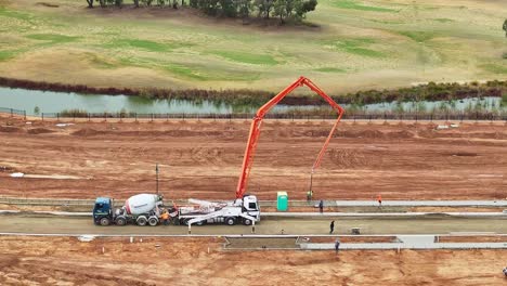 Construction-workers-using-concrete-pumper-at-new-construction-stage-in-Yarrawonga