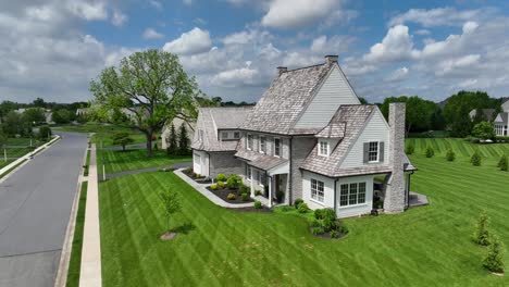 Aerial-of-18th-century-style-homes-with-steep-pitched-cedar-roofs-and-copper-gutters-and-downspouts