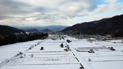 Snow-covered-outskirts-of-Yamanouchi-with-farmland-property-boundaries-defined-on-cold-winter-day,-Japan