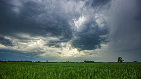 Timelapse-Of-Clouds-Over-Agricultural-Field-At-Sunset