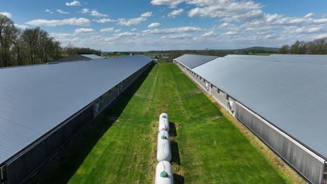 Aerial-flight-between-industrial-silos-on-farmstead