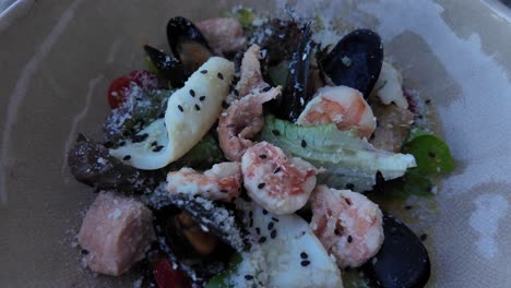 A-close-up-shot-of-a-seafood-salad-with-black-sesame-seeds