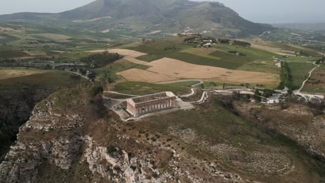 Aerial-of-Archaeological-Park-of-Segesta-ruins-in-Sicily-,-Italy-main-old-temple-ruins