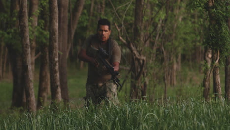 Hispanic-Soldier-With-Rifle-Looks-Around-While-Walking-In-Wilderness