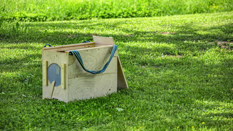 Wooden-Bee-Hive-In-An-Apiary-With-Bees-Flying-Time-lapse