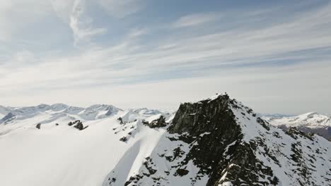 Rocky-mountains-of-Norway-covered-in-snow,-aerial-view