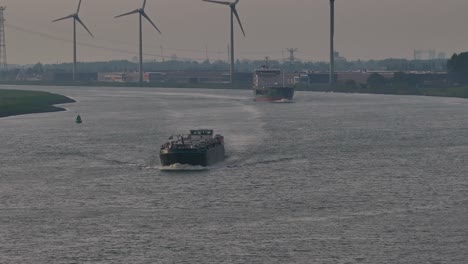 Tanker-Ships-With-Wind-Turbines-In-The-Background-Near-Moerdijk,-Netherlands