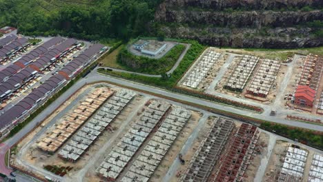 Aerial-views-drone-flyover-Goodview-Heights-residential-areas-capturing-rows-of-terraced-houses-under-construction,-hillside-landscape-and-mountainous-terrains,-Kajang,-Malaysia,-Southeast-Asia