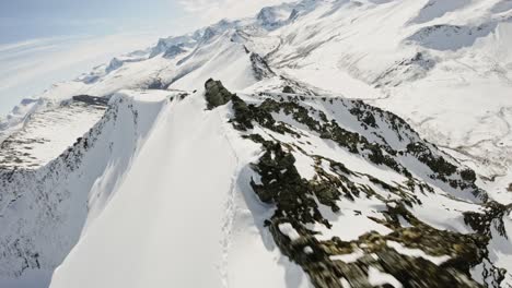 Winter-mountain-ridge-in-Norway,-aerial-FPV-view