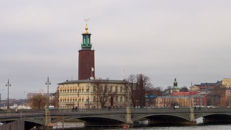 Stockholm-City-Hall-Tower-With-Busy-Centralbron-In-Foreground,-Stockholm,-Sweden,-Wide-Shot