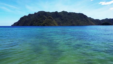 Coron-Harbor-Aerial-Above-Sea-Flying-Towards-Uson-Island