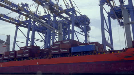 DP-world-container-terminal-in-kochi,-a-cargo-ship-waiting-for-loading-,crane-and-containers-loading-containers-in-cargo-ship