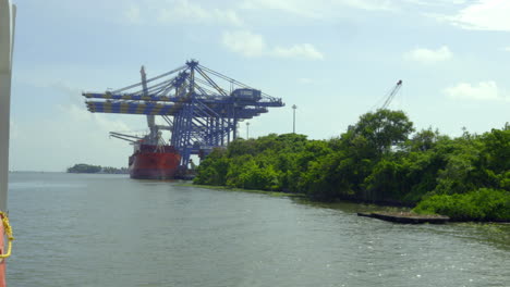 DP-world-container-terminal-in-kochi,-a-cargo-ship-waiting-for-loading-,crane-and-containers-loading-containers-in-cargo-ship