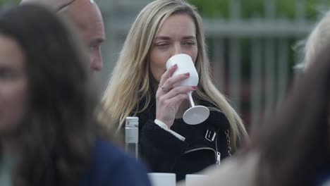 Slow-motion-shot-of-a-woman-drinking-wine-from-a-plastic-wine-glass