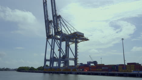 DP-world-container-terminal-in-kochi,-a-cargo-ship-waiting-for-loading-,crane-and-containers-loading-containers-in-cargo-ship