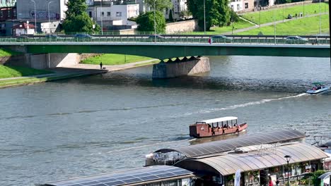 Old-boat-heading-towards-Most-Dębnicki,-Krakow,-Poland