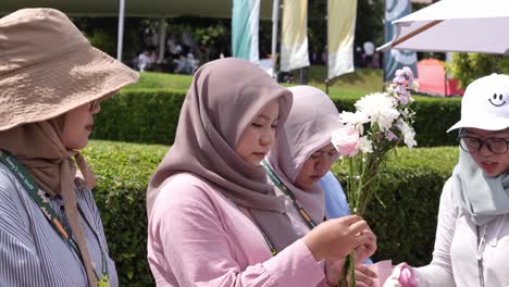 Indonesian-girl-wearing-hijab-crafts-flowers-into-a-bouquet-together