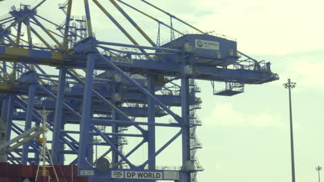 DP-world-container-terminal-in-kochi,-a-cargo-ship-waiting-for-loading-,crane-and-containers-loading-containers-in-cargo-ship