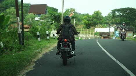 Biker-is-driving-motorbike-during-road-trip-in-Indonesia