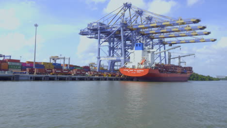 DP-world-container-terminal-in-kochi,-a-cargo-ship-waiting-for-loading-,crane-and-containers-loading-containers-in-cargo-ship