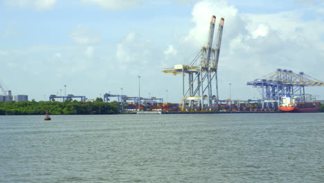 DP-world-container-terminal-in-kochi,-a-cargo-ship-waiting-for-loading-,crane-and-containers-loading-containers-in-cargo-ship