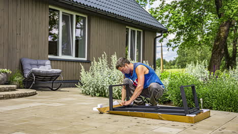 Man-putting-together-a-patio-coffee-table---time-lapse