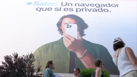 A-low-angle-shot-captures-a-prominent-billboard-by-Apple,-the-American-multinational-technology-company