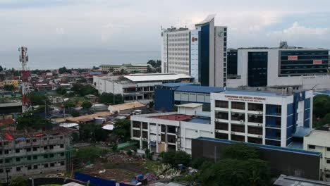 The-Philippine-Bureau-of-Internal-Revenue-Building-stands-amidst-a-bustling-residential-estate,-reflecting-urban-development-and-modern-architecture