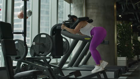 young-woman-doing-pump-squats-with-weights-in-gym,-staying-fit,-full-body-workout