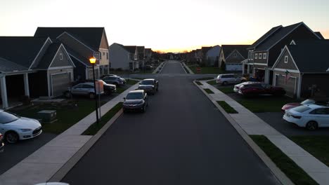 Slow-flight-over-street-with-parking-cars-and-lighting-lantern