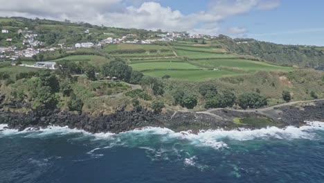 Beautiful-coastal-road-and-volcanic-rocky-cliffs-of-Santo-Antonio,-Sao-Miguel-of-Azores-islands,-aerial