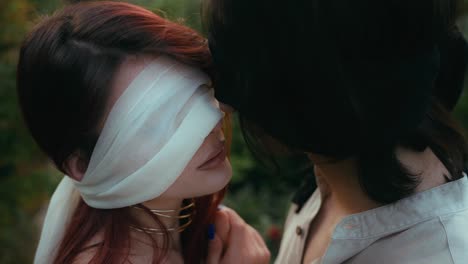 cinematic-close-up-shot-of-Young-couple-hugging-and-blindfolded-while-kissing