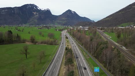 Switzerland-highway-motorway-near-Swiss-Alps-mountains,-aerial-drone-video