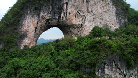 Descending-drone-reveals-hikers-on-a-wooden-platform-admiring-Yueliang-Shan-landscape