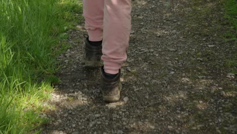 Woman-in-Hiking-Boots-Walking-on-Forest-Path-on-Sunny-Day