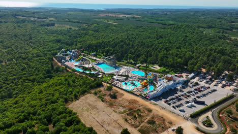 Establishing-drone-shot-of-the-Aquapark-Istralandia,-sunny-day-in-Istria,-Croatia