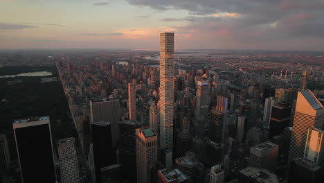 Aerial-tilt-shot-of-the-432-Park-Ave-Tower-in-midtown-Manhattan,-during-golden-hour-in-New-York-City