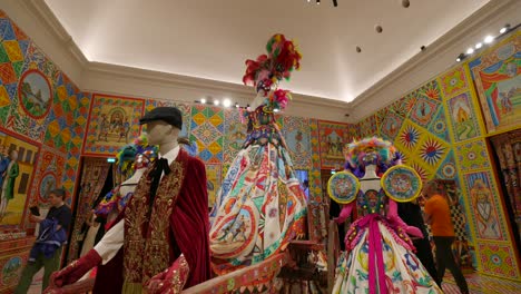 Dolce-And-Gabbana-Luxurious-Fashion-dresses-on-mannequin-displays-showcased-in-exhibition-room,-exuding-a-sense-of-opulence-and-artistic-flair