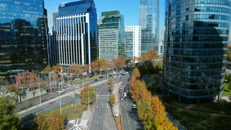 Aerial-fly-Providencia-commercial-neighborhood-of-Santiago-de-Chile,-high-rise-buildings-and-traffic-in-autumn-daylight