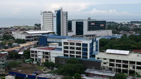 The-Philippine-Bureau-of-Internal-Revenue-Building-stands-amidst-a-bustling-residential-estate,-reflecting-urban-development-and-modern-architecture